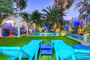 A pool area with lounge chairs, a pool, and tropical plants. - Villa in Marrakesh—La Badira neighborhood—Hammamet, with a pool 300 meters from the beach (hammamet)