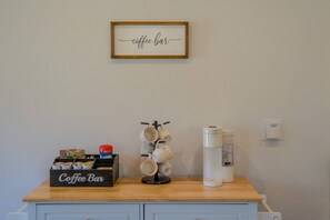 A coffee bar setup with a coffee maker, mug holder, and a coffee bar sign on a wooden counter. - Fall Escape Special: 15% Discount Ends Nov 30! Must book by Oct 18 (Pagosa Springs)
