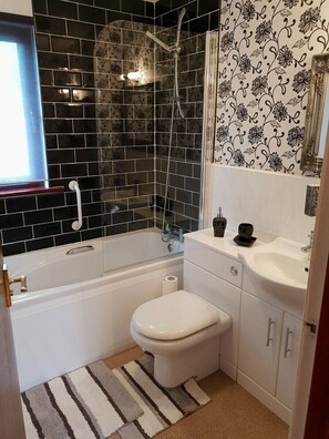 A bathroom with a bathtub, toilet, and shower. - Cala Gran Holiday Park - Holiday Accommodation 7934 (Fleetwood)
