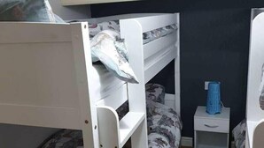 A bunk bed room with a white wardrobe and a small bedside table. - Cala Gran Holiday Park - Holiday Accommodation 9426 (Fleetwood)