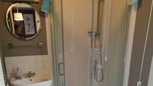 A bathroom with a glass-enclosed shower, a pedestal sink, and a toilet. - Cala Gran Holiday Park - Holiday Accommodation 9426 (Fleetwood)