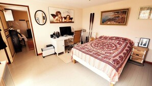 A bedroom with a bed, a desk, a chair, a television, and a painting on the wall. - Book your stay at Villa Bella Vista, Liguria (Apricale)