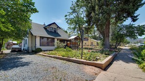 A residential property with a house, a driveway, and a gravel area.