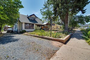 A residential property with a house, a driveway, and a gravel area.