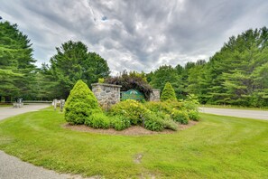 A stone sign with 'Pinebrook' written on it, surrounded by well-maintained grass and trees. - All-Season Fun! Shanty Creek Resort Condo (Bellaire)