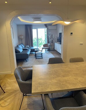 A modern living room with a sofa, coffee table, and dining area. - Just perfect St.Jacob apartment  (Dubrovnik)
