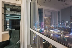 A modern room with a large window overlooking a cityscape at night. - FIRST CLASS |2BR| Marina Views | Near JBR Beach (JBR)