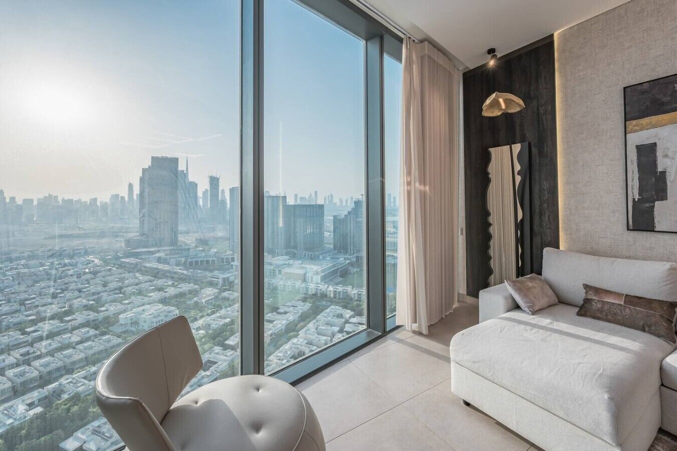 A modern bedroom with a large window, a bed, a chair, and a pendant light.