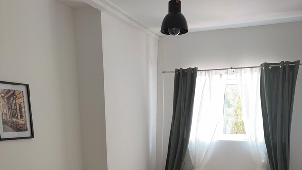 A bedroom with a bed, a window with curtains, a picture on the wall, and a wooden floor. - Fully renovated country house (Barville)