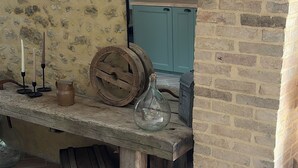 A rustic interior with a stone wall, a wooden bench, a blue cabinet, and a tiled floor. - Fully renovated country house (Barville)