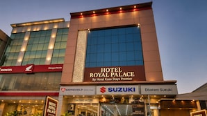 A hotel with a prominent sign for 'Hotel Royal Palace' and a large glass facade.