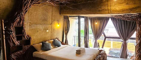 A room with a bed, curtains, and a view of the outside.