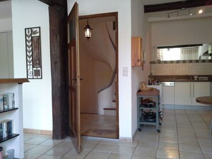 A kitchen with a dishwasher, a small table, and a cabinet. - A romantic getaway on the square in Saint-Chinian, featuring fantastic hiking and wine (saint-chinian)