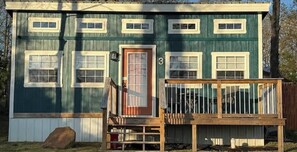 A single-story house with a front porch, a door, and a number '3' on the side. - Justice-Cabin-3 @ Eagle Hollow (goreville)