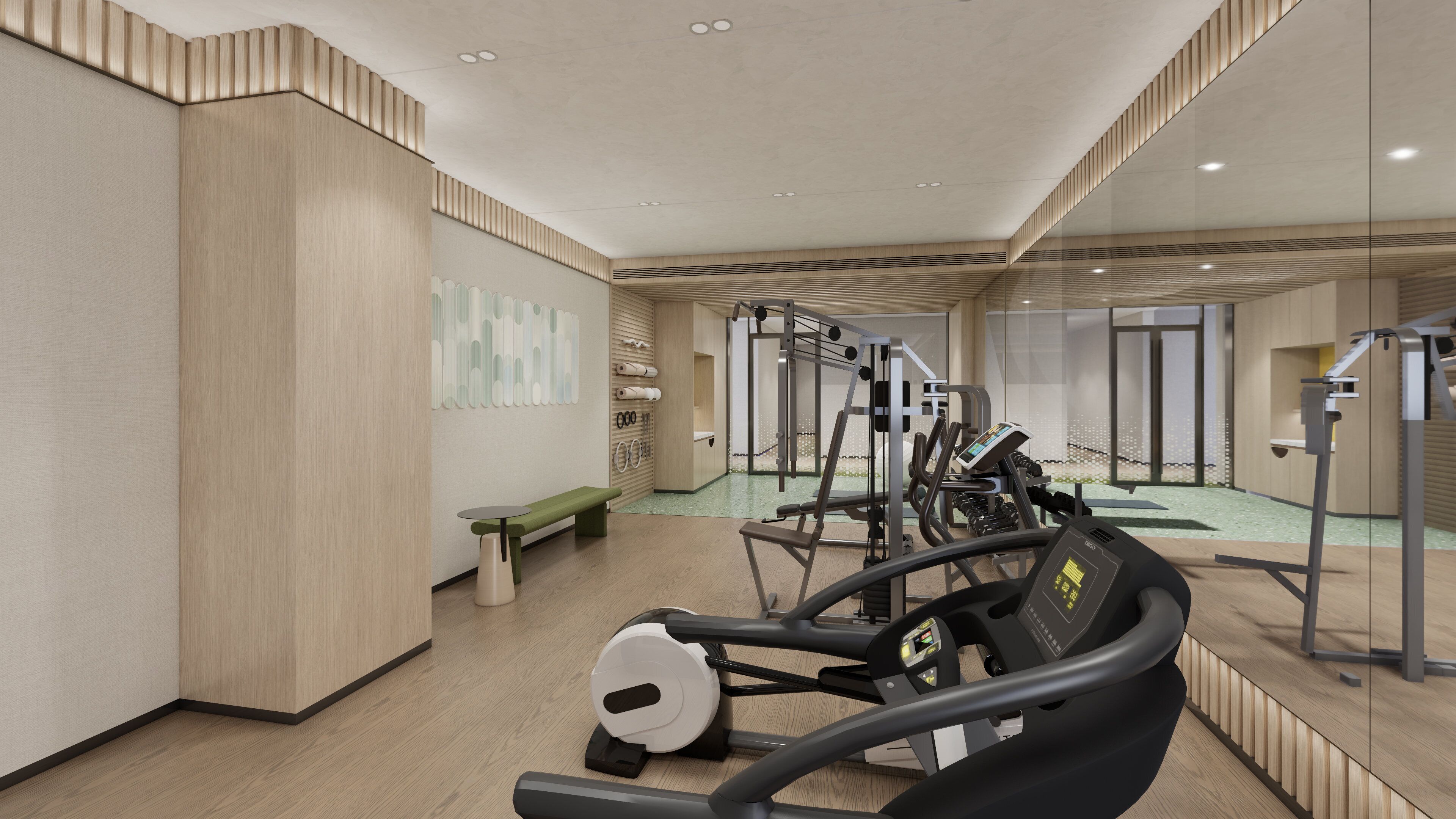A modern gym with exercise equipment, a bench, and a wall with abstract art.