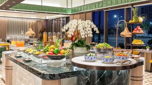 A buffet with a variety of fruits, vegetables, and prepared dishes. - Holiday Inn Shanghai Necc by IHG (Shanghai)