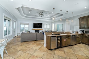 A spacious kitchen with a large island, built-in appliances, and a flat-screen TV. - Sandy Heels | 6BR Crystal Beach Home with Gulf Views, Private Pool & Steps to Beach | Sleeps 20 (Destin)