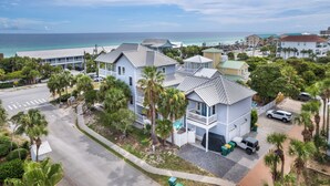 A coastal residential area with houses featuring balconies and a view of the ocean. - Sandy Heels | Steps to the Beach | Pool | Pet Friendly (Destin)