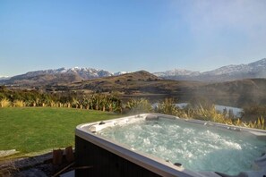 A hot tub with a view of mountains and a lake. - Noa by the Lake Queenstown by MajorDomo | Grand Lakefront Retreat for 14 with Spa Pool, Pilates Studio & Private Gym (Lake Hayes Estate)