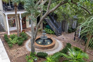 A courtyard with a fountain, brick pathway, and a staircase leading to an upper level. - 2 Bedroom condo at Fisherman’s Wharf inside Sandestin Golf and Beach Resort (Miramar Beach)