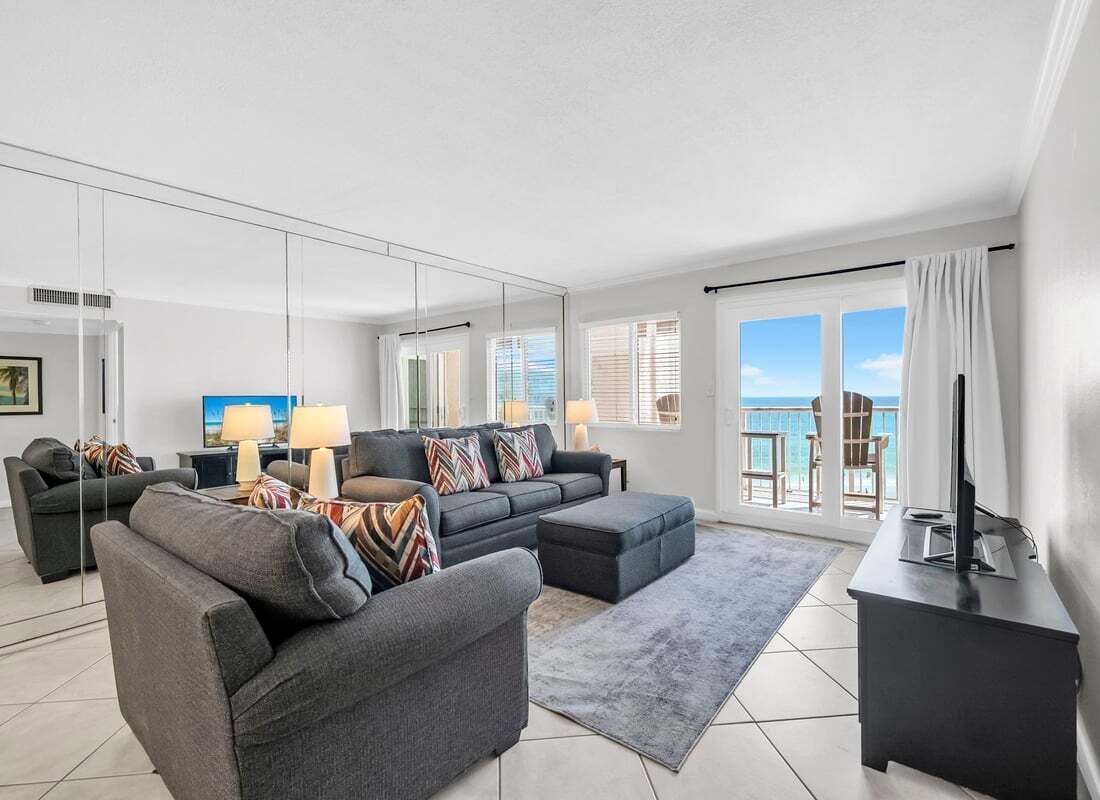 A modern living room with a sofa set, a coffee table, and a TV on a stand.