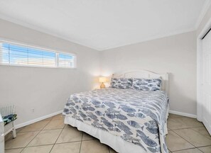 A bedroom with a bed, a nightstand, a lamp, and a window. - (621) Gulf-Front Condo on 6th Floor, Sleeps 6, Kings, FREE Beach Service (Destin)