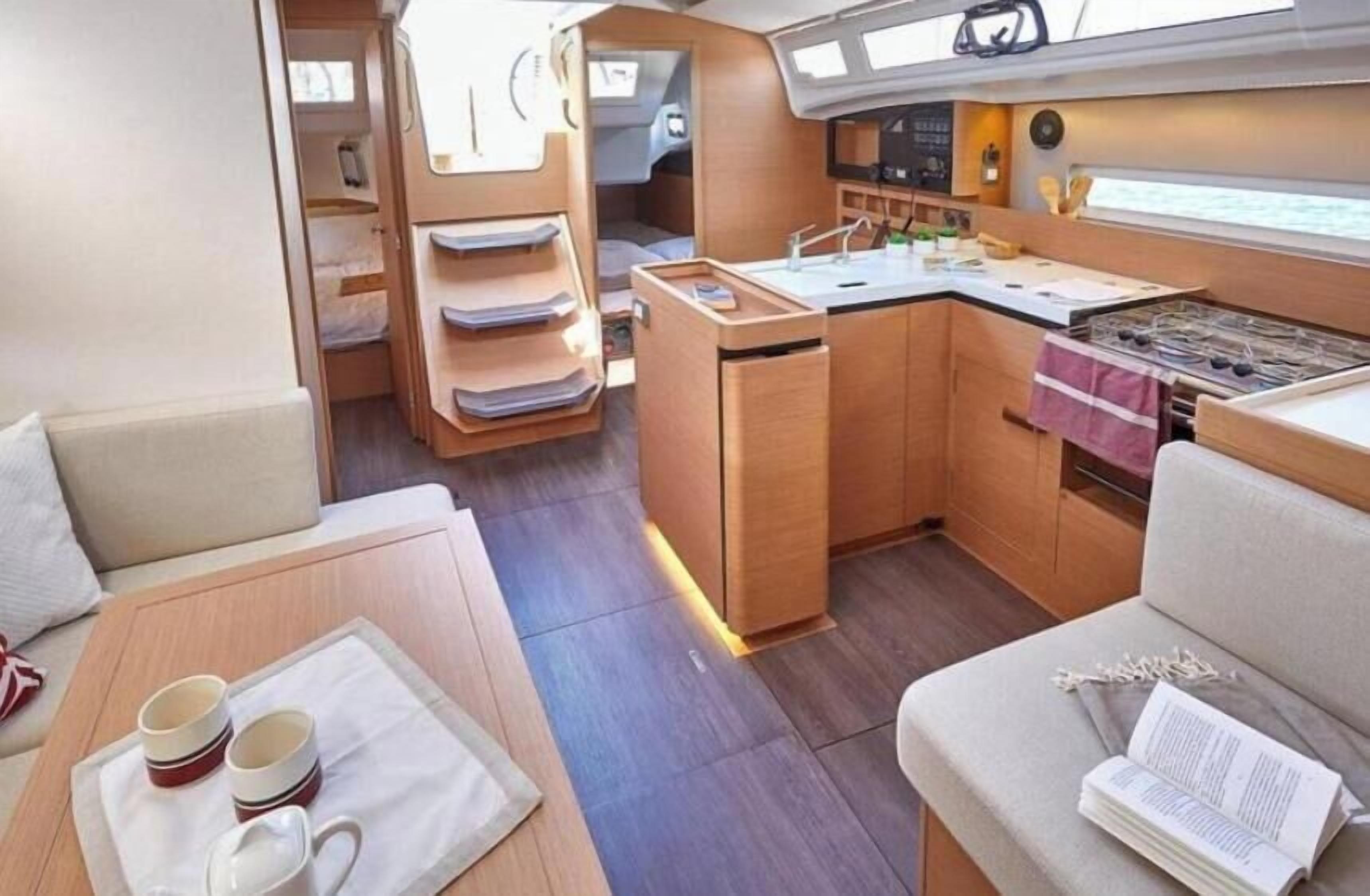 A compact kitchen area with a stove, sink, and storage cabinets.