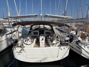A marina with multiple sailboats docked, featuring a prominent 'POLARIS' logo on the bow of one boat. - Sun Odyssey 410 - POLARIS (Dalmacija Marina)