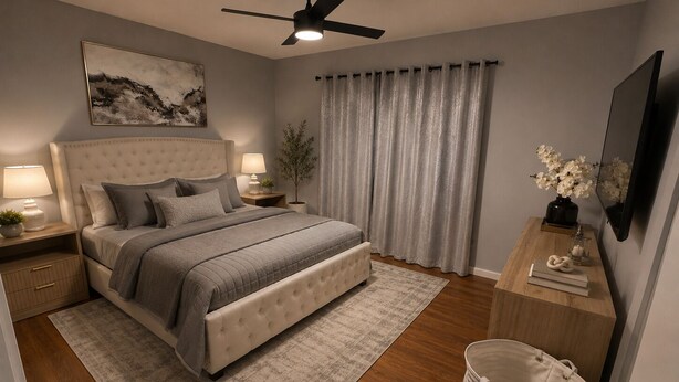 A bedroom with a bed, nightstands, a ceiling fan, a large window with curtains, a TV, and a small table with decorative items. - Elegance, tranquility, and comfort. Close to everything. (Schenectady)