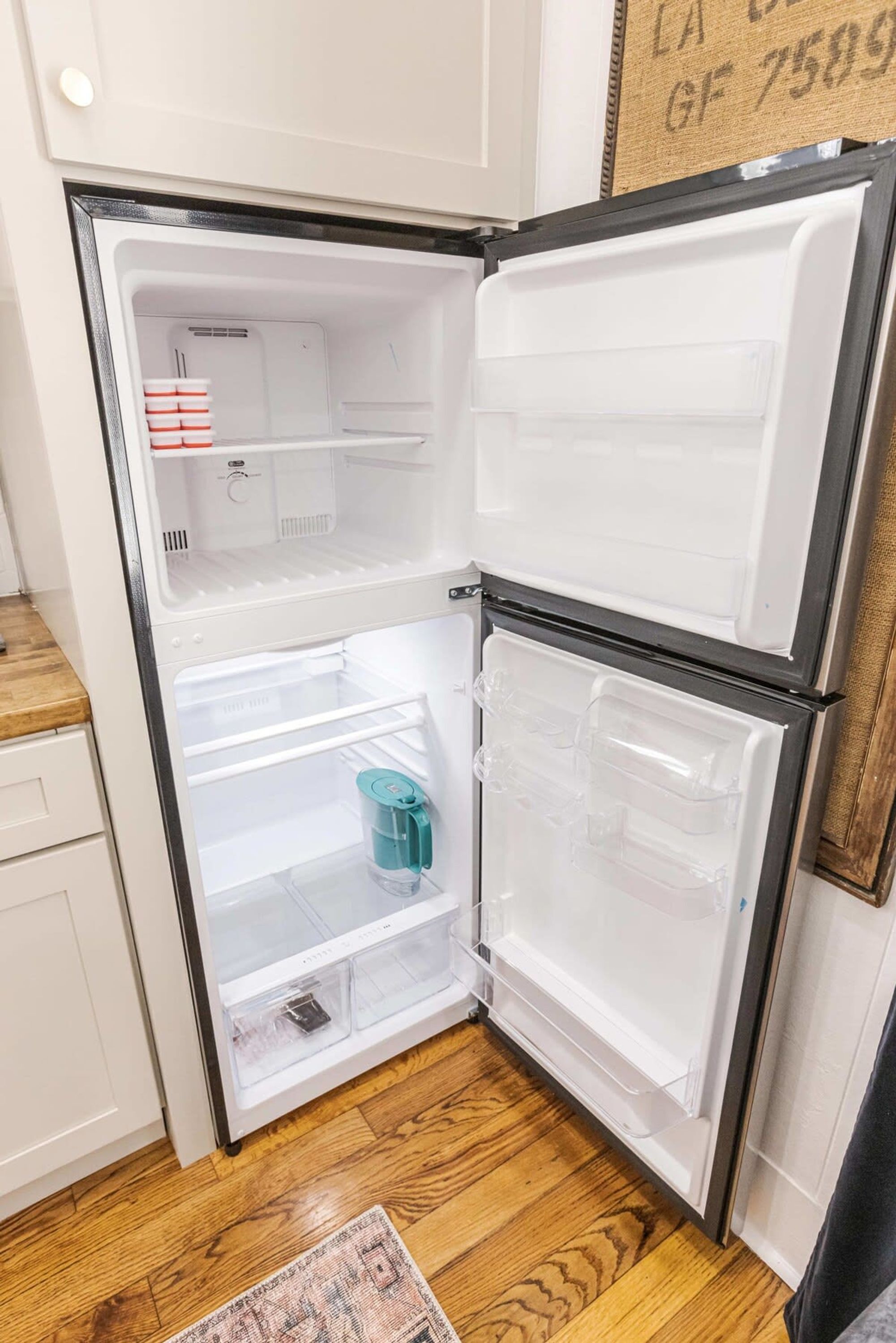 A compact refrigerator with two door compartments, a built-in ice maker, and a water dispenser.