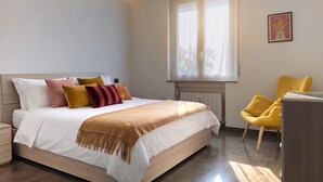 A bedroom with a bed, bedside table, window, and a chair. - Casa Bonvicino Citt Studi (Milan)