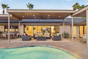 A covered outdoor area with a pool, seating, and a view of the interior. - Elegant South-end (Less Wind) 3BD/3BA Right On The Fairway! (Palm Springs)
