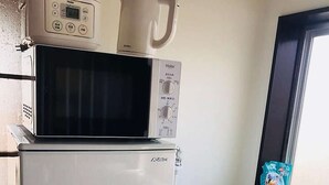 A compact kitchen with a microwave, a refrigerator, and a washing machine. - LunaStay Apartments - 301 (東京)