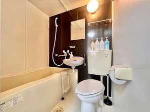 A modern bathroom with a bathtub, toilet, sink, and shower. - LunaStay Apartments - 302 (東京)
