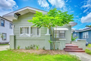 A two-story house with a green exterior, white trim, and a small tree in the front yard. - Grill & Porch! Extended Escape, 2 Mi to Ybor City (Tampa)