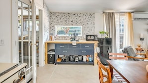A compact kitchen with a dining area, a built-in microwave, and a refrigerator. - Grill & Porch! Extended Escape, 2 Mi to Ybor City (Tampa)
