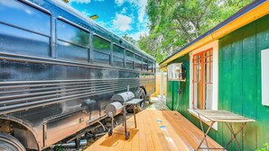 A train parked next to a green building with a wooden deck. - Grill & Porch! Extended Escape, 2 Mi to Ybor City (Tampa)