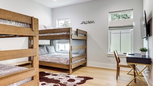 A bunk bed room with a desk and chair, a cowhide rug, and a window with blinds. - Walk to Shore! Family-friendly Canyon Lake Retreat (Canyon Lake)