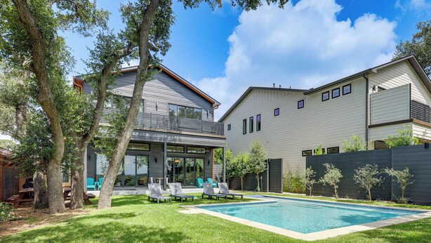 A modern house with a swimming pool, a patio with lounge chairs, and a well-maintained lawn. - Waterfront Canyon Lake Getaway w/ Lakeshore Park (Canyon Lake)