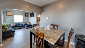 A dining area with a table, chairs, and a sofa. - Fenced Yard! Spacious Home, 4 Mi to Dtwn Milwaukee (Milwaukee)
