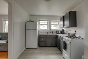 A kitchen with a refrigerator, microwave, stove, and cabinets. - 5 Blocks to Sand! Pet-friendly Unit in Ocean Grove (Ocean Grove)