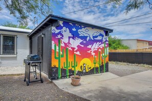 A small building with a colorful mural, a barbecue grill, and a potted plant. - Desert Studio 5 Mi to Dtwn Tucson w/ Shared Yard (Tucson)