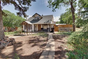 A two-story house with a covered porch and a stone pathway leading to the entrance. - Walk to SSU & Shakespeare Fest! Colorful Retreat (Cedar City)