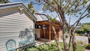 A house with a covered porch, two outdoor chairs, a tree, and a bicycle in the background. - Walk to SSU & Shakespeare Fest! Colorful Retreat (Cedar City)