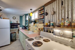 A kitchen with a white stove, a sink, and various kitchen utensils and appliances. - Walk to SSU & Shakespeare Fest! Colorful Retreat (Cedar City)