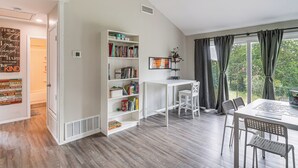 A room with a white bookshelf, a desk, and a dining area with chairs. - Great for Families! Schertz Getaway 6 Mi to Zoo (Cibolo)