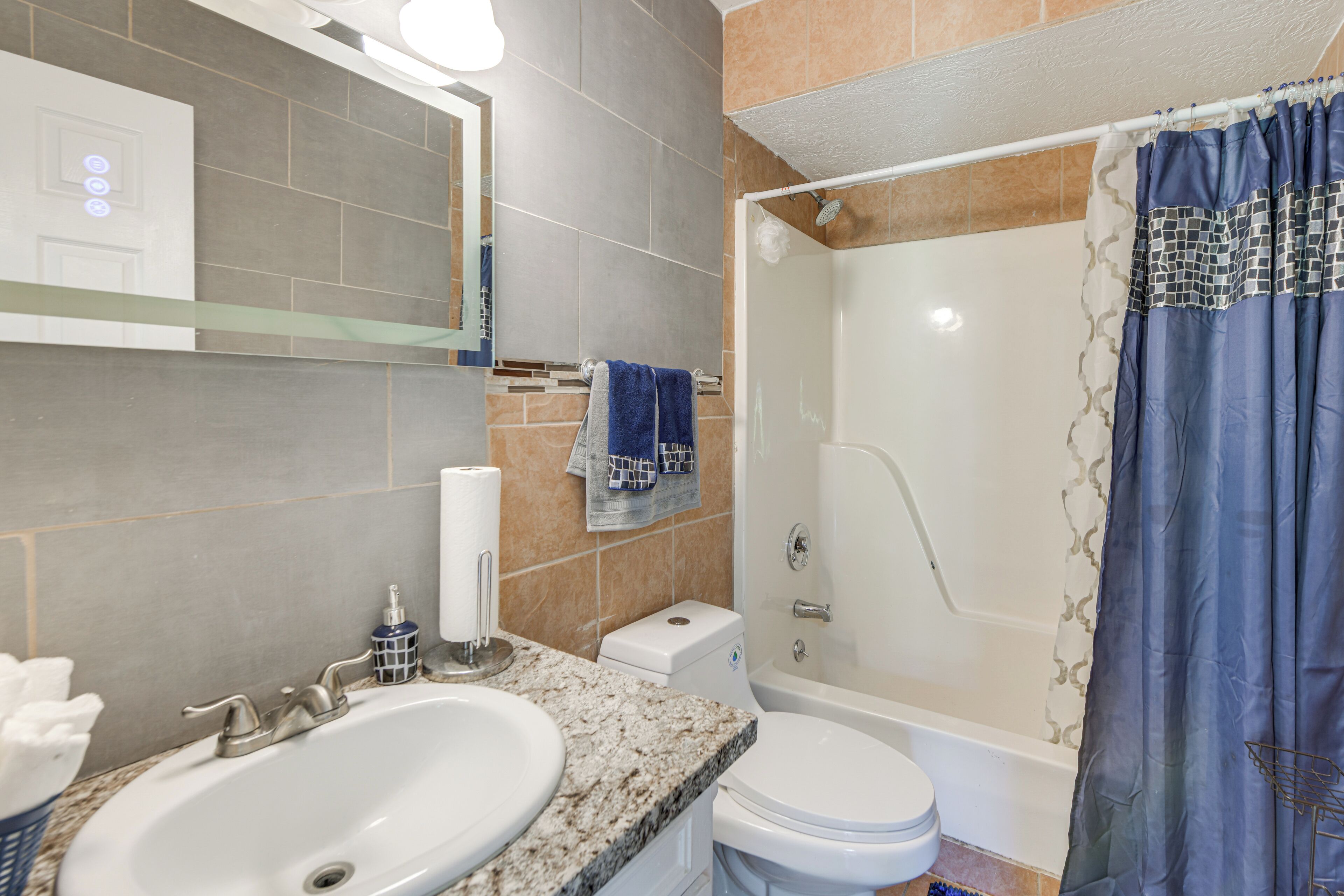 A bathroom with a sink, toilet, and shower.