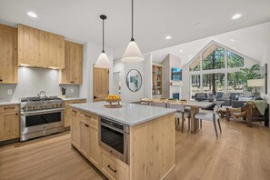 A modern kitchen with wooden cabinets, stainless steel appliances, and a central island. - NL33A | 56457-1 Elk Run Drive (Sunriver)