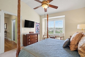 A bedroom with a bed, a ceiling fan, a television, and a window. - Havens 1136 Back on Program! Beautiful & Spacious! In Barefoot Resort! (North Myrtle Beach)