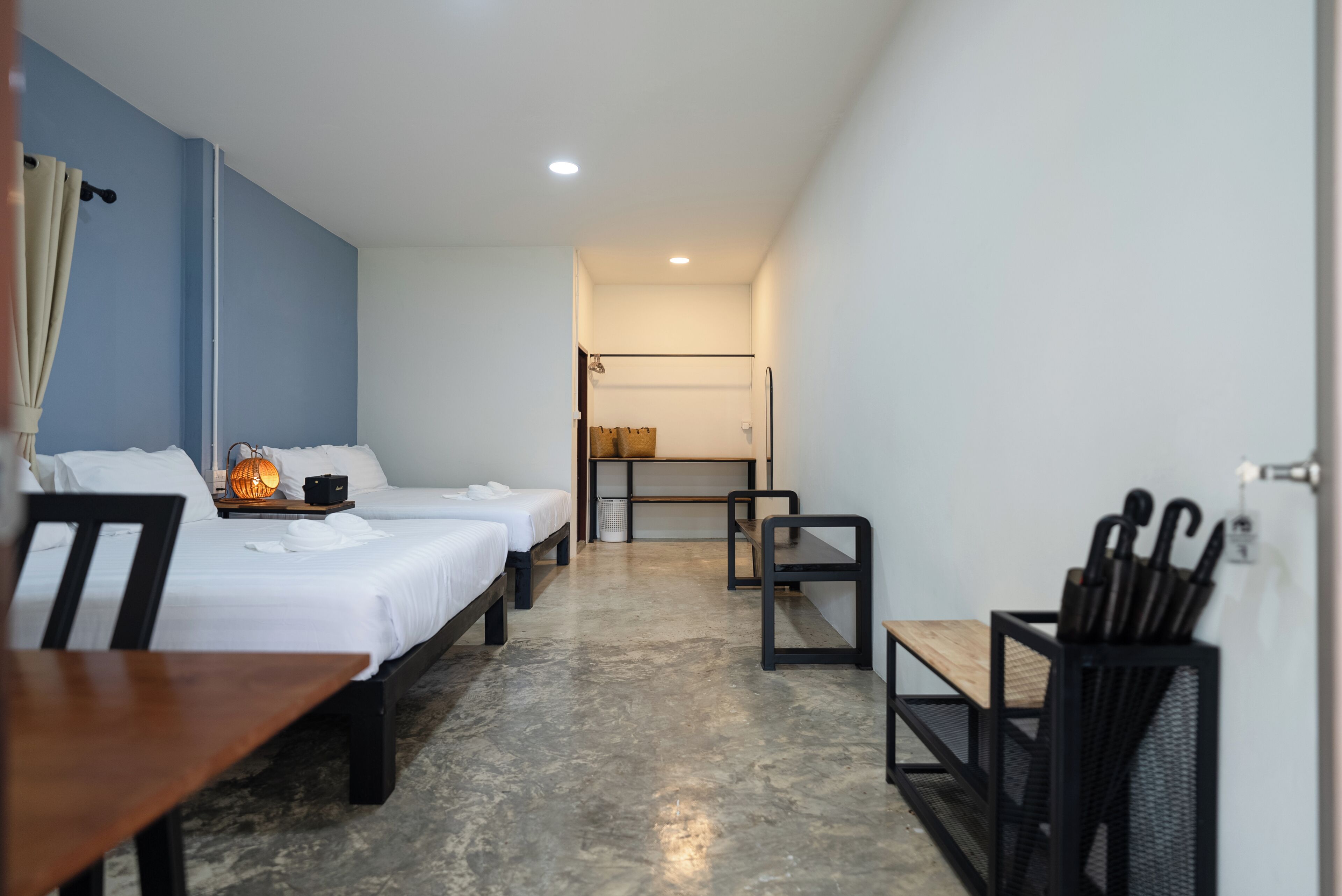 Ein Hotelzimmer mit zwei Betten, einem Esstisch und einer kleinen Sitzecke.